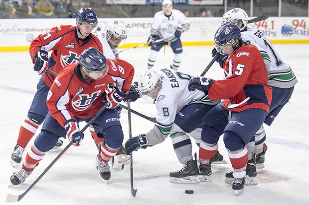 Seattle's Scott Eansor battles a Lethbridge force for control of the puck during WHL play Friday night.