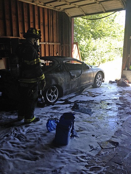 A garage fire injured a Kent man and severely damaged his car at a home on East Hill Sunday.