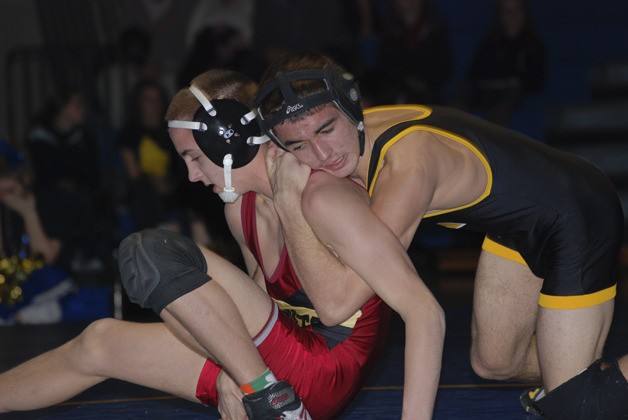 Tahoma’s Cruz Velasque tries to work Enumclaw’s Tyke Reid to his back to gain valuable points in the 113-pound match during the Battle of the Bone on Jan. 27.