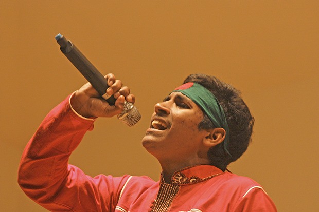 Ridoy Alom sings a patriotic song from Bangladesh during the Bangladeshi Community in the South Puget Sound cultural event at the Kent Senior Activity Center last Saturday night.