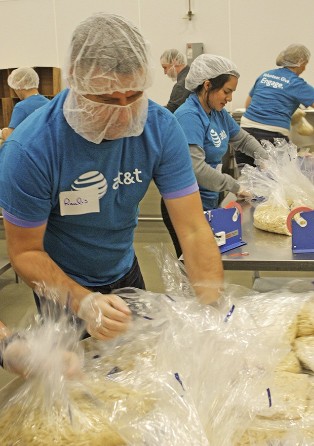 Raulis Petronis and volunteers repackaged bulk food donations into family-size portions for people in need during the AT&T PNW Cares event.