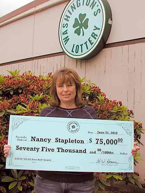 Kent resident Nancy Stapleton holds a giant check in observance of winning a jackpot through Washington's Lottery.