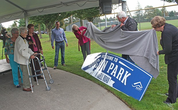 City officials and family members help unveil the Hogan Park archway sign in honor of former mayor Isabel Hogan