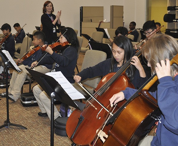 Students in Monica Camp's orchestra class at Excel Public Charter School rehearse for a concert last December. All students at the Kent-based school learn to play an instrument.