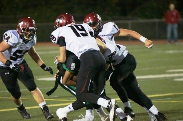 The Eastlake defense collapses on a Kentwood ball carrier during district playoff action Friday night at French Field.