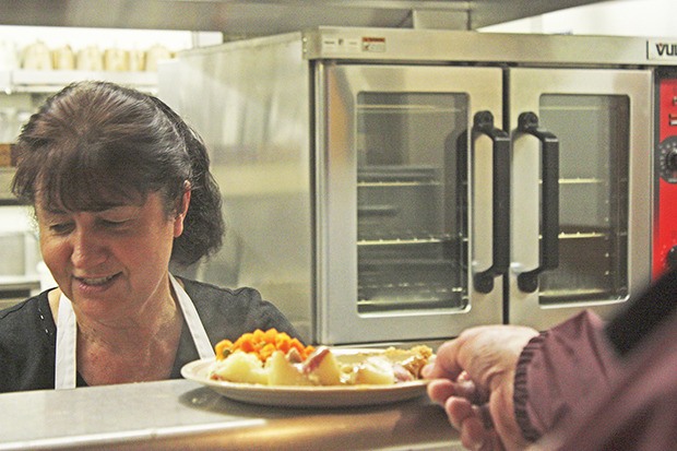 Nellie Dondarets serves up lunch during the Kent Parks Deli & Cafe's 20th anniversary celebration at the Kent Senior Activity Center last Friday.