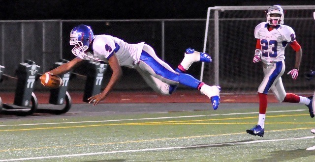 Kent-Meridian's Quincy Carter dives into the end zone to score one of his three rushing touchdowns against Auburn Riverside on Friday night.