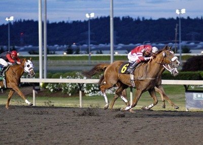 Mr. Mad Max and Deborah Hoonan-Trujillo forge to the lead in the feature race at Emerald Downs July 8.