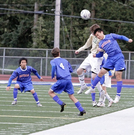 04/27/10 Kentridge's Wesley Leonard and Kent-Meridian's Eddie Zhao fights for a header with Kentridge's Wesley Leonard at French Field Tuesday. The Chargers knocked off the Royals