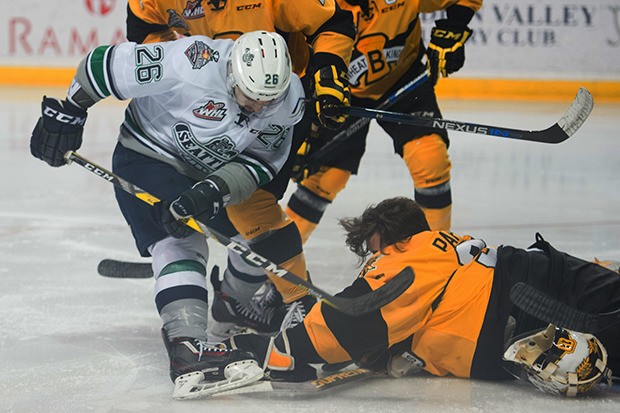 Brandon goalie Jordan Papirny falls on the puck in front of Seattle's Nolan Volcan during Game 5 WHL finals action Friday night.