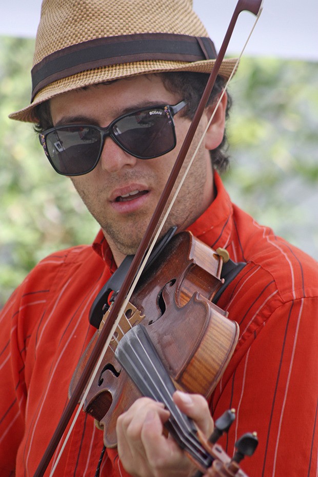 Violinist Ranger Sciacca of the Ranger & the Re-Arrangers performs a gypsy tune during the Take Out Tuesday Kent Summer Concert Series at Kent Station. The band plays gypsy jazz