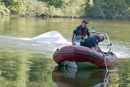 Crews tow an abandoned