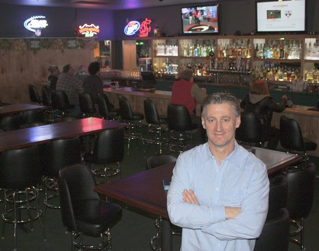 Bruce Schultz stands in front of his new business