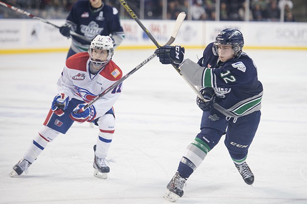 The Thunderbirds' Ryan Gropp shoots as the Chiefs' Markson Bechtold defense during WHL action Sunday.