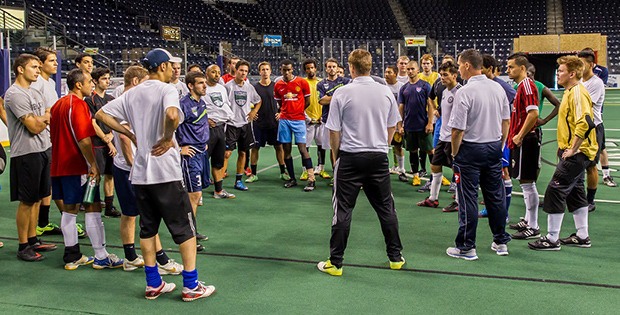 Impact FC coaches huddle with players at the team tryouts inside the ShoWare Center last weekend.