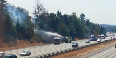 A brush fire breaks out last year along I-5 near South 216th Street