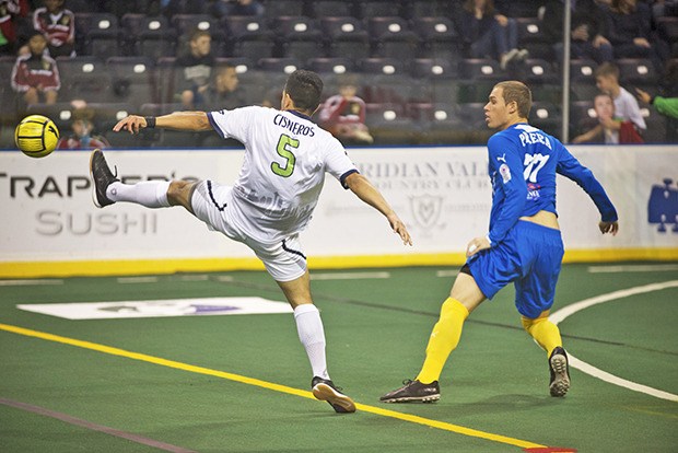 Seattle Impact's Francisco Cisneros battles Sockers forward Nick Perera for the ball during MASL action at the ShoWare Center on Saturday night.