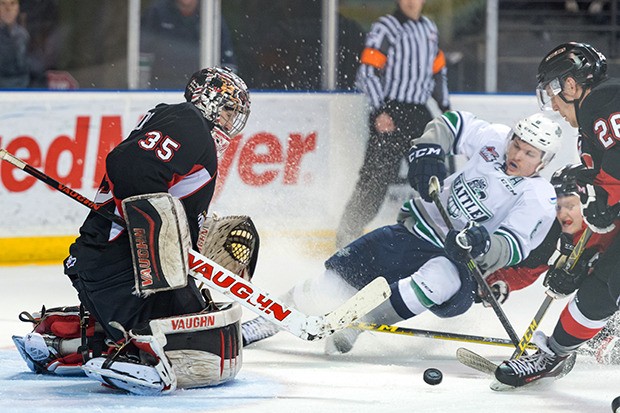 The Thunderbirds' Scott Eansor skates into position to attempt a shot at Cougars goalie Ty Edmonds during Game 2 playoff action Saturday night.