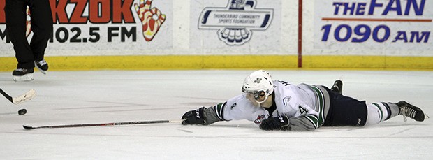 The Thunderbirds' Adam Henry delivers a poke check during Game 3