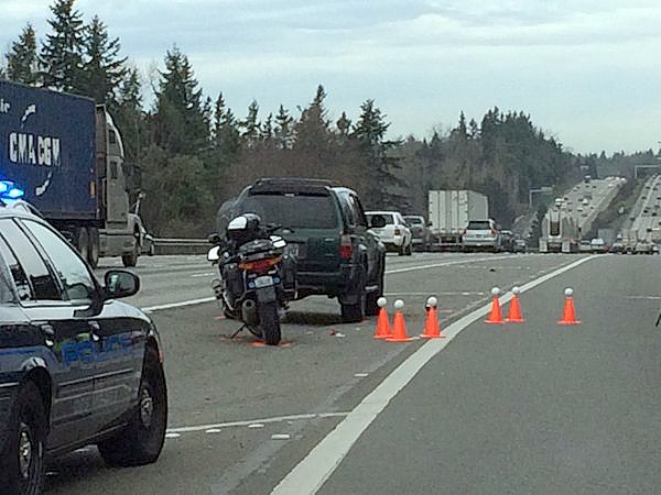 Police mark the spot where a vehicle hit a State Patrol trooper who had stopped his motorcyle and was conducting a traffic stop along Interstate 5 near South 272nd Street. The trooper was injured and taken to Harborview Medical Center in Seattle.