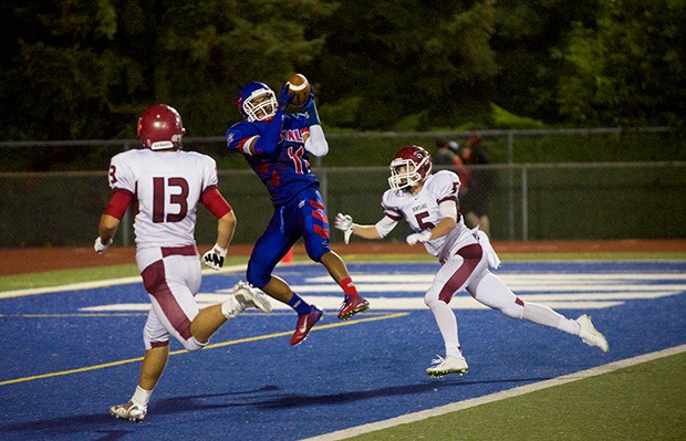 Kent-Meridian's Marc Dennis snags one of his two touchdown passes against Kentlake on Friday night.