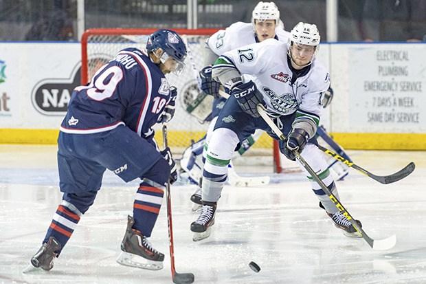 The Thunderbirds' Ryan Gropp and the Americans' Tyler Sandhu scramble for the puck during WHL play Tuesday night.