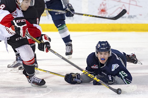 The Thunderbirds' Donovan Neuls tumbles to the ice in pursuit of the puck during WHL play at the ShoWare Center on Tuesday night.