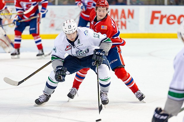 The Thunderbirds' Mathew Barzel takes the puck the other way with the Chiefs' Dominic Zwerger behind him.