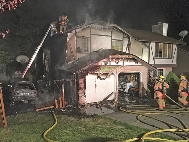 Kent firefighters contained and doused a house fire in the 27000 block of 35 Place South early Monday morning. All three people were able to get out safely