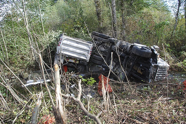 Washington State Patrol arrested the adult male driver on suspicion of DUI after the dump truck and trailer he was driving had veered off the highway and jack-knifed into Jenkins Creek between Covington and Maple Valley at 12:08 this afternoon.