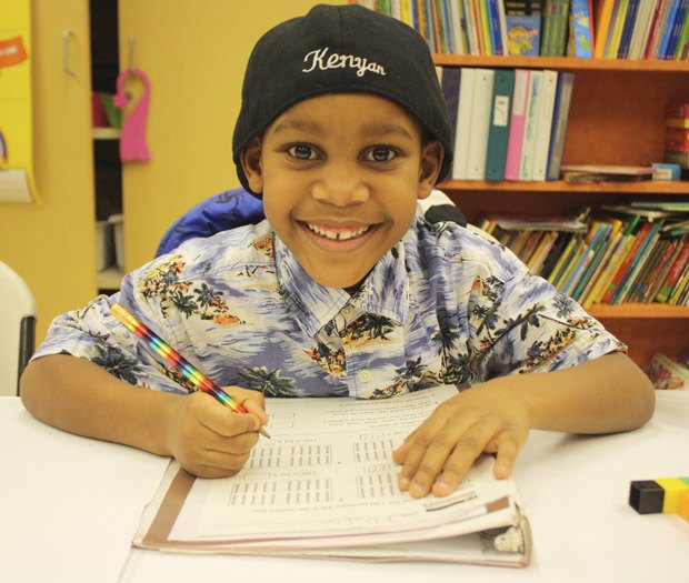 After-school study session: Ibrahim Hassan finishes up homework and worksheets provided by the staff at the Birch Creek Youth Center.