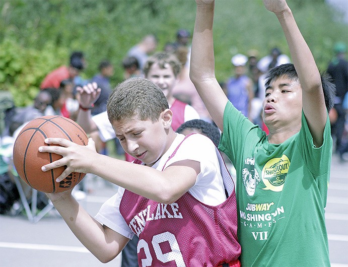 Players battle along the baseline during the ShoWare Shootout 3-on-3 basketball tournament last Saturday. A field of 122 teams competed on 14 courts over two days for division titles.