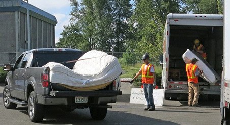 A driver drops off a mattress at the June 7 Kent Recycling Event at the Kent Phoenix Academy.