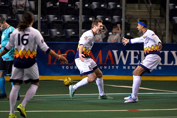 Dan Antoniuk (12) celebrates with teammates after a Stars goal.