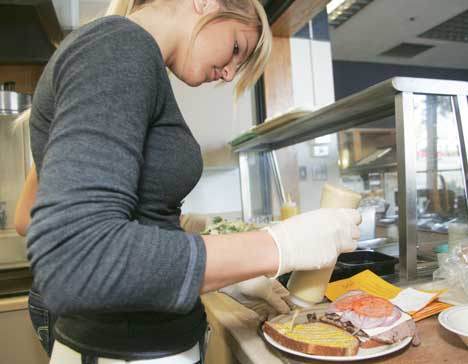 A worker prepares a sandwich at the Kent Parks Deli & Cafe at the Kent Senior Activity Center.