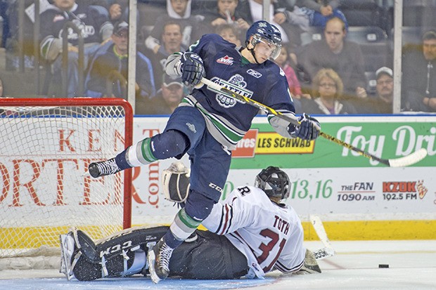 The Thunderbirds' Ryan Gropp battles for the puck in front of Rebels goalie Rylan Toth.