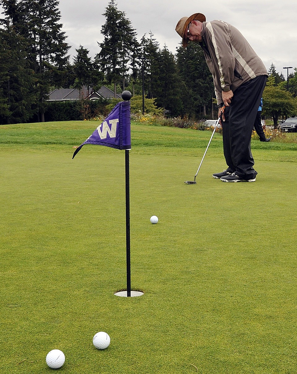 Charlie Brown competes in the putting contest during the Scramble for Safe Families Golf Tournament at Washington National last Saturday in Auburn. Tournament proceeds benefitted the Kent-based Jennifer Beach Foundation in its efforts to provide education