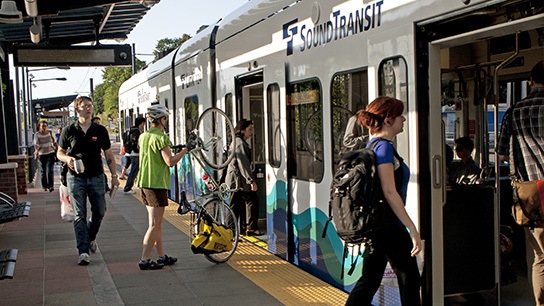 Riders catch a light rail train.