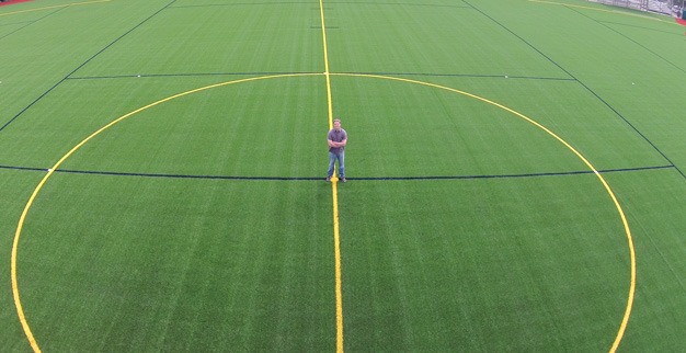 Kent parks planner Brian Levenhagen stands on the new synthetic turf at Wilson Playfields.