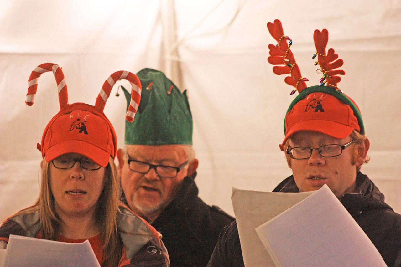 Members of the Kent Lutheran Church sing Christmas carols in the Town Square Plaza during Winterfest last year. The celebration returns to the plaza this Saturday with music, storytelling, hot drinks and snacks and the ceremonial tree lighting. MARK KLAAS, Kent Reporter