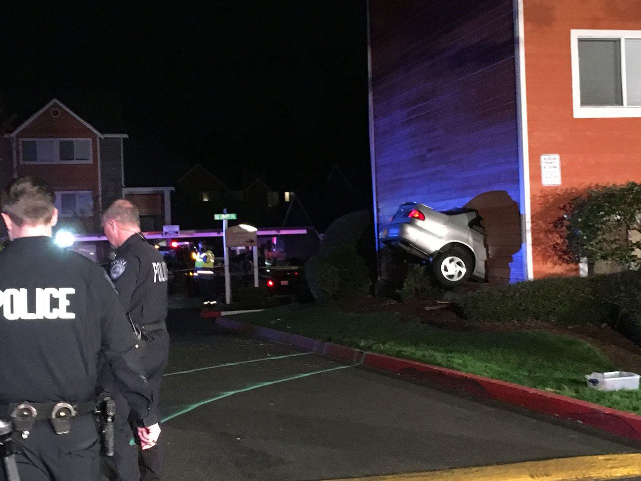 Kent Police and Kent RFA firefighters were on the scene after a vehicle struck an apartment building in the 10800 block of Southeast 240 Street on Saturday night. A man inside the apartment complex was killed, police reported. The two people in the car were not injured. COURTESY PHOTO, Kent RFA