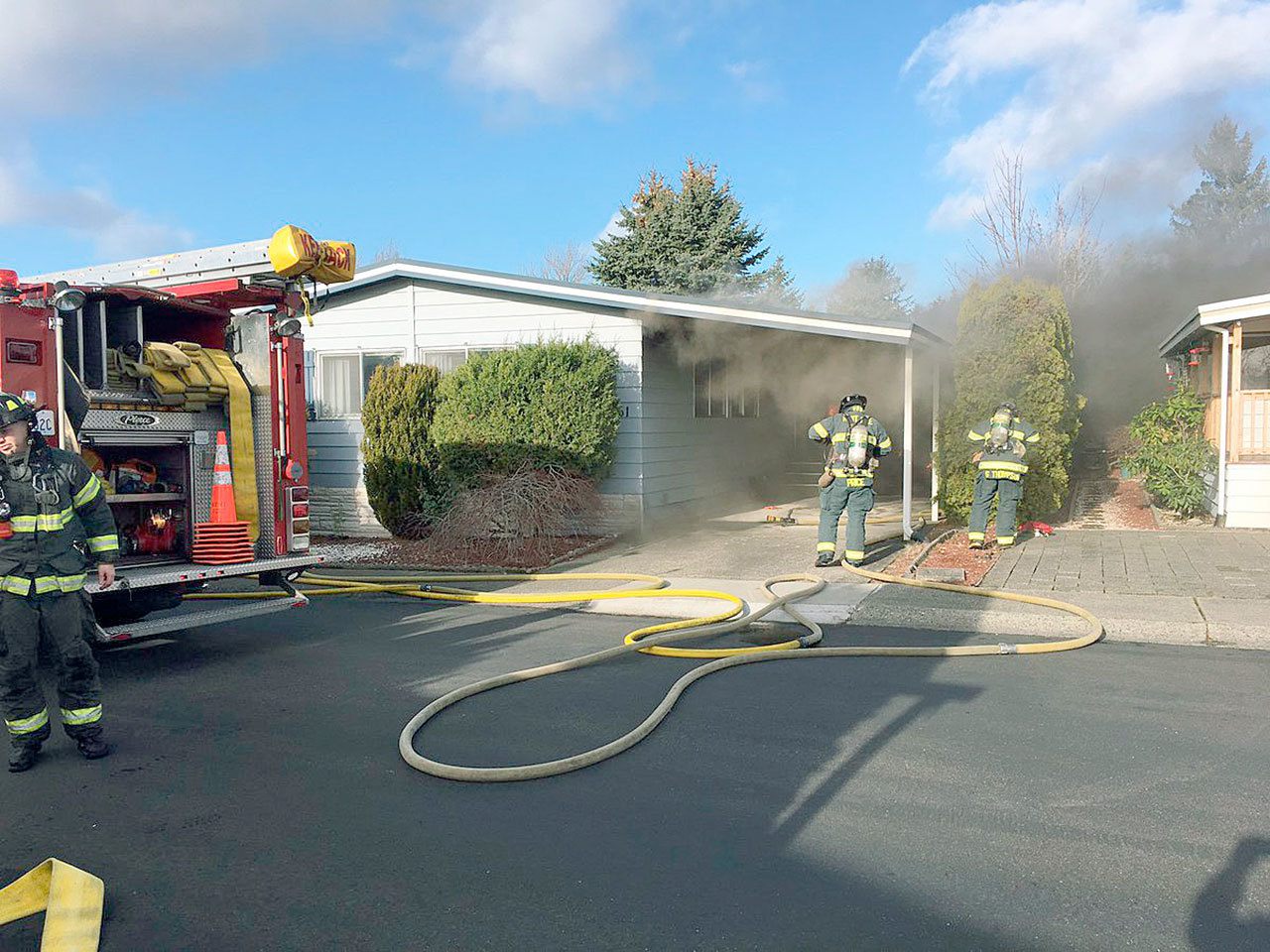 Firefighters take on a mobile home fire in the 20800 block of 116th Avenue SE on Tuesday, Dec. 20.