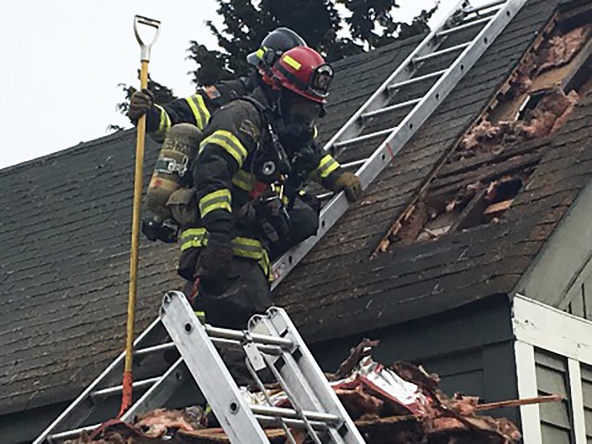 Firefighters from Puget Sound Fire attack and put out a fire at a two-story home in Kent on Saturday afternoon. COURTESY PHOTO