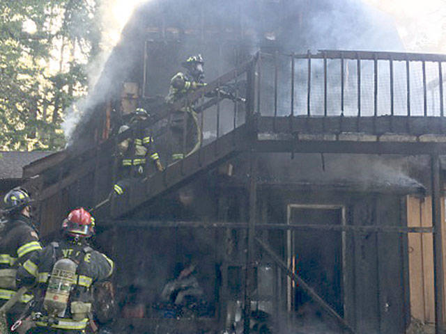 Firefighters battle a blaze on Tuesday morning at a home in the 26600 block of 148th Avenue Southeast. Courtesy Photo/Puget Sound Fire