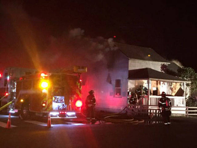 Fire crews battle to extinguish a house fire in the 200 block of East Willis Street on Sunday evening. COURTESY PHOTO, Puget Sound Fire