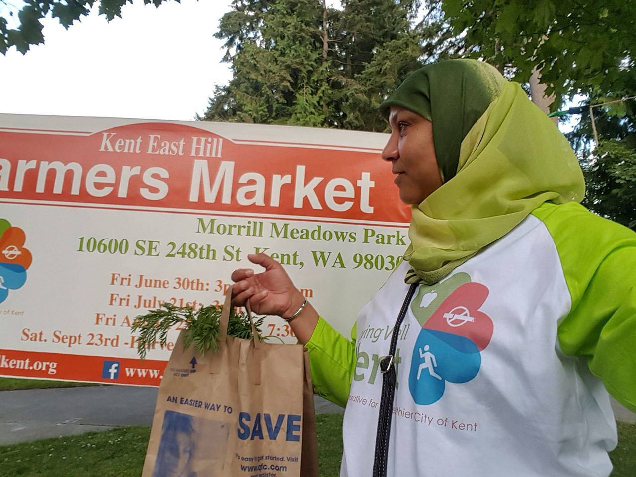 Risho Sapano, Living Well Kent board member, shops at the new farmers market on Kent’s East Hill. COURTESY PHOTO