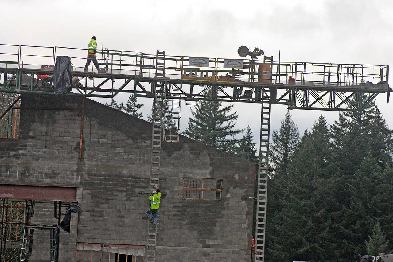 Crews from Neeley Construction continue work Tuesday on the new Covington Elementary School, scheduled to open in the fall. MARK KLAAS, Kent Reporter