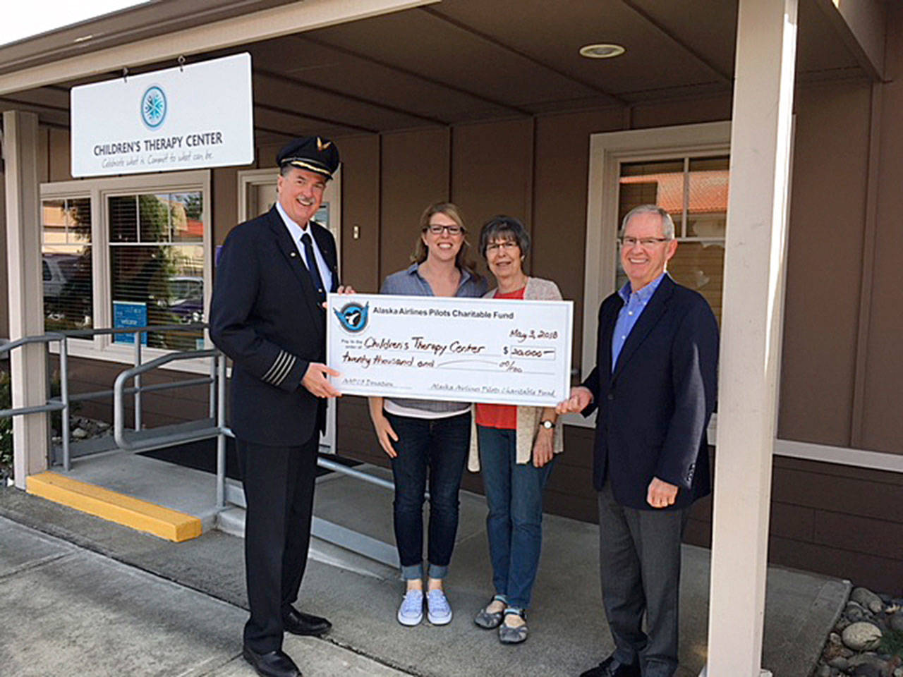 At the ceremony are, from left: Dan Hoffman, president of the Alaska Airlines Pilots Charitable Fund; Laura Anderson, physical therapist at Children’s Therapy Center; Jean Gronewald, friend of CTC; and Barry Gourley, CTC CEO. COURTESY PHOTO