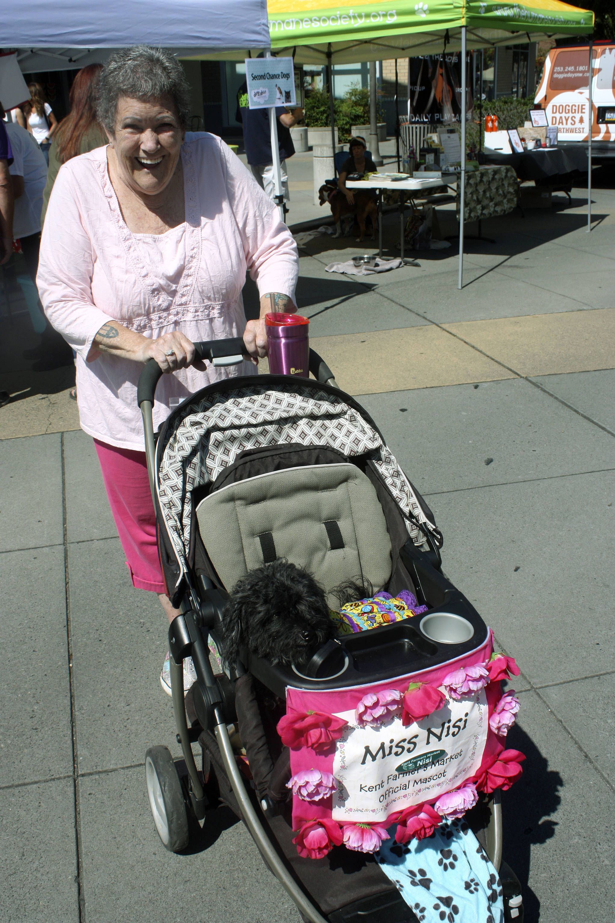 Linda Butler and her dog, Miss Nisi, stroll through the event. The Kent woman and her 10-year-old poodle mix are frequent visitors to the Kent Farmers Market or other downtown events. MARK KLAAS, Kent Reporter