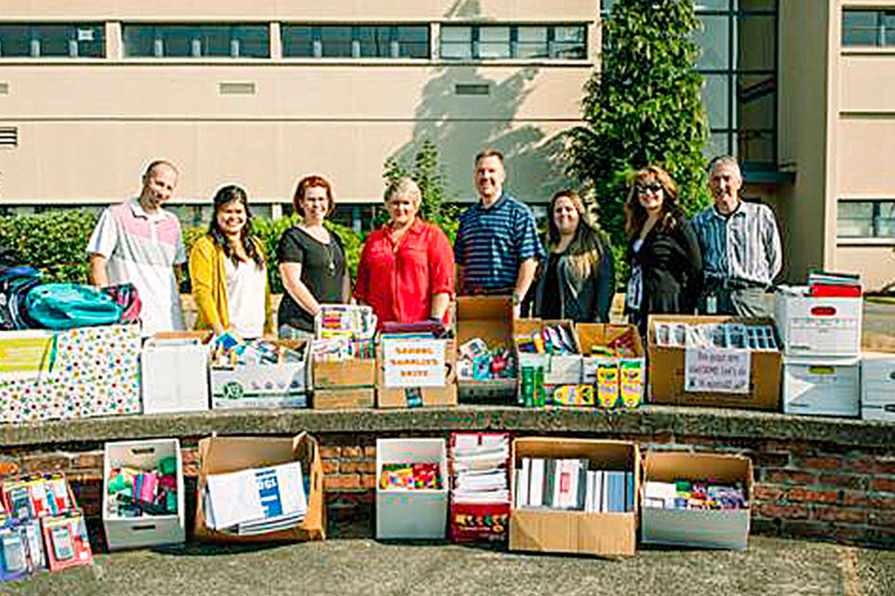 City employees donate school supplies, cash to Kent-Meridian High School